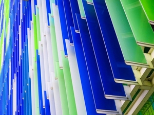 a lot of green white and blue acrylic sheets stacked on one another