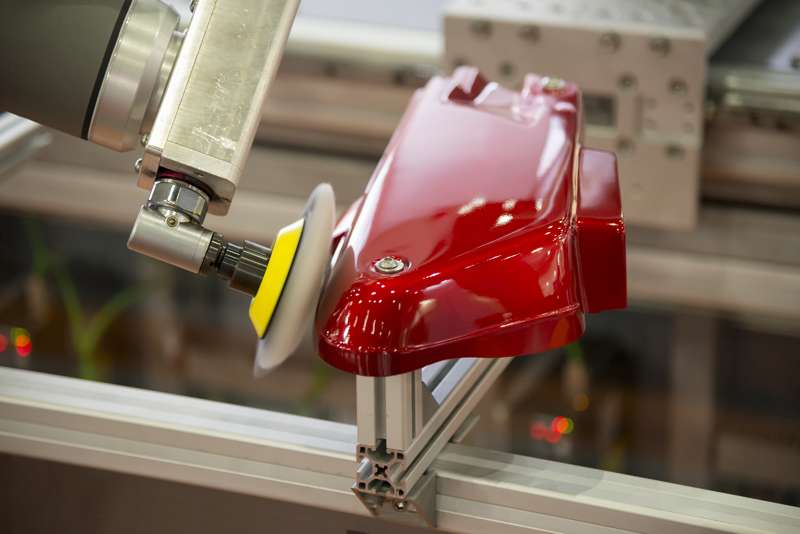 The robot arm polishing the automotive part