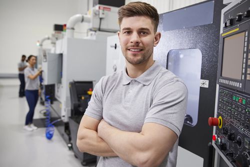 A man in a workshop against the background of machines and equipment