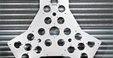 triangular steel part with holes on a garage door