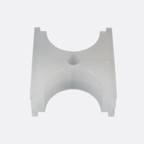 milled curved plastic part with a hole through the middle