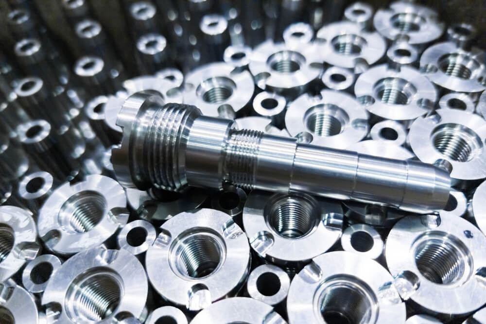 Shiny steel parts close-up background, long clean steel rods after fine cnc turning.