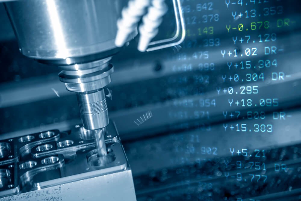The CNC machining center with the G-code data background. — Photo